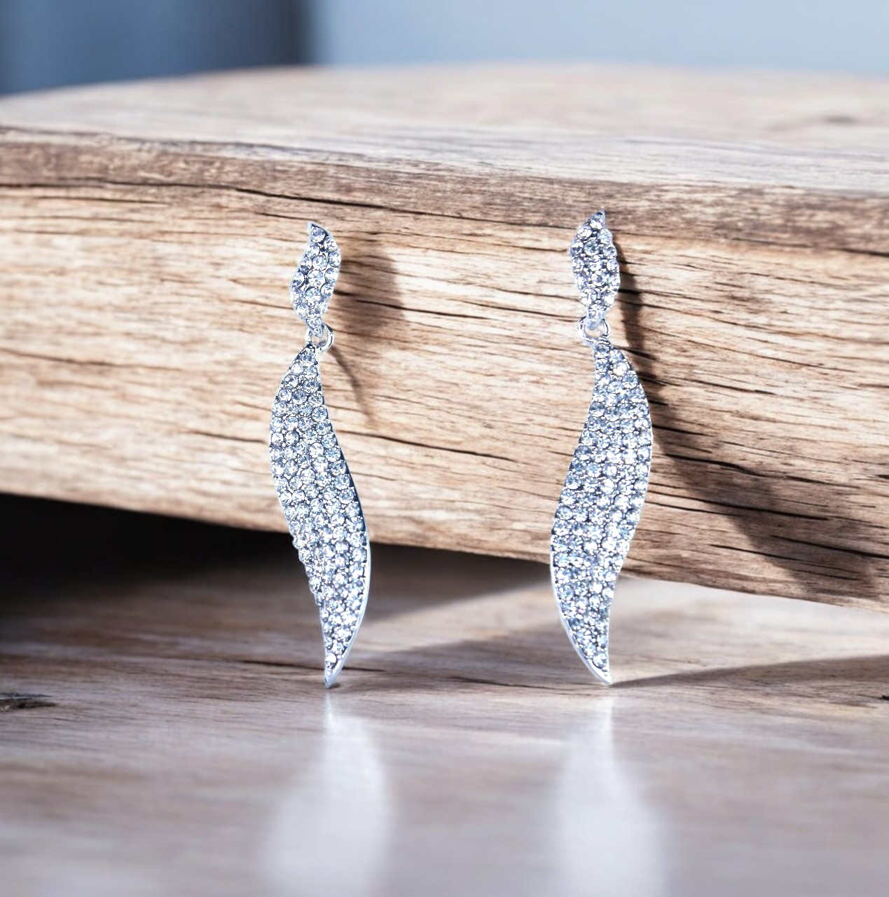 Reet & Riwaz's Shimmery Flame Silver Drop Earrings, zirconia Silver Plated Drops & Danglers for beautiful ladies.